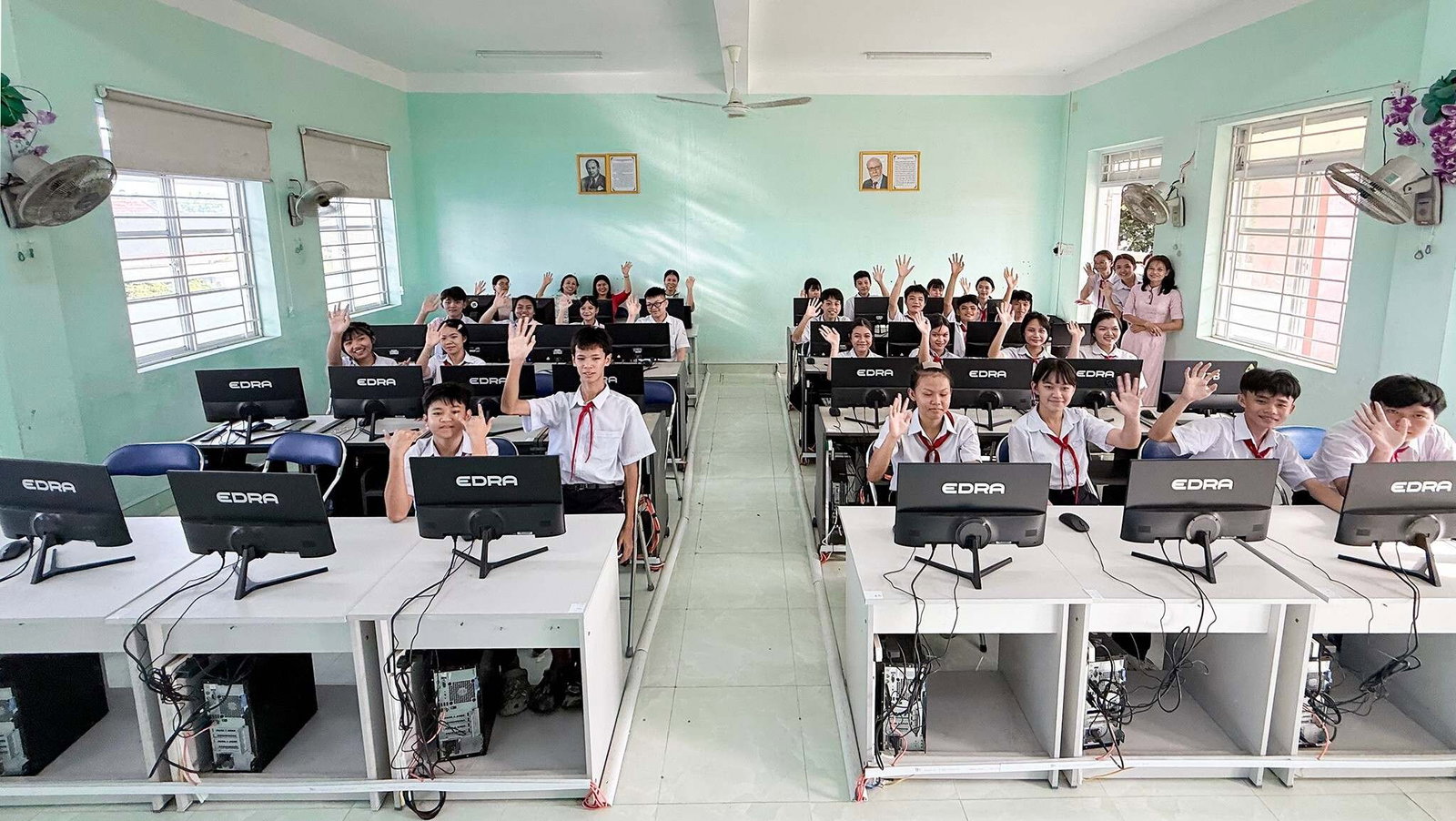 Students and teachers gather in their newly equipped computer lab.